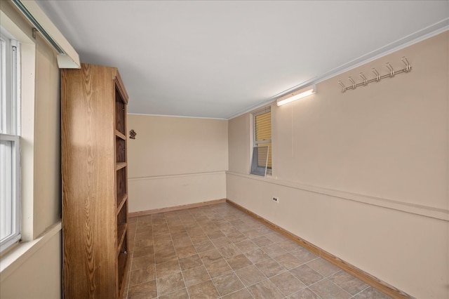 empty room featuring crown molding