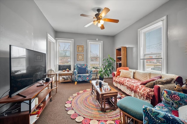 carpeted living room with ceiling fan