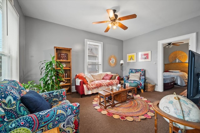 living room with dark colored carpet, plenty of natural light, and ceiling fan