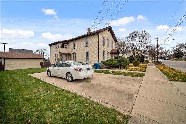 view of side of property with a yard