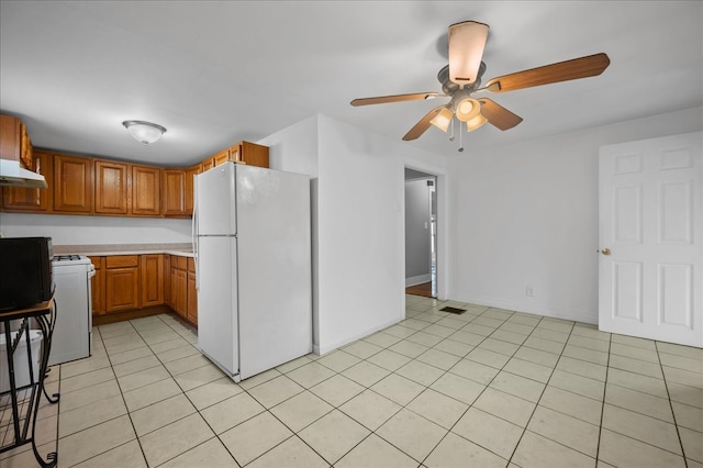 kitchen featuring ceiling fan, light tile patterned flooring, and white appliances