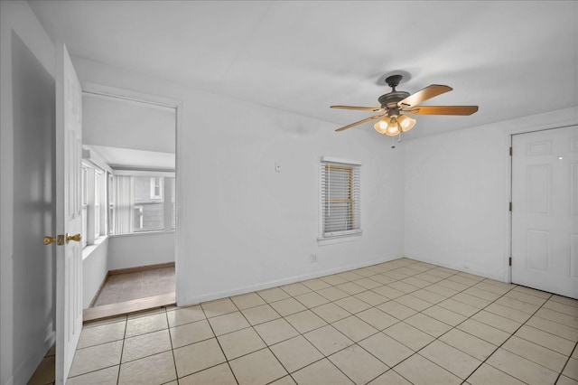 spare room featuring ceiling fan and light tile patterned floors