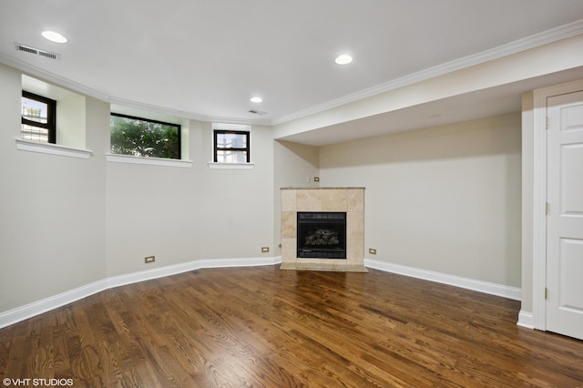 interior space featuring a fireplace, crown molding, and dark wood-type flooring