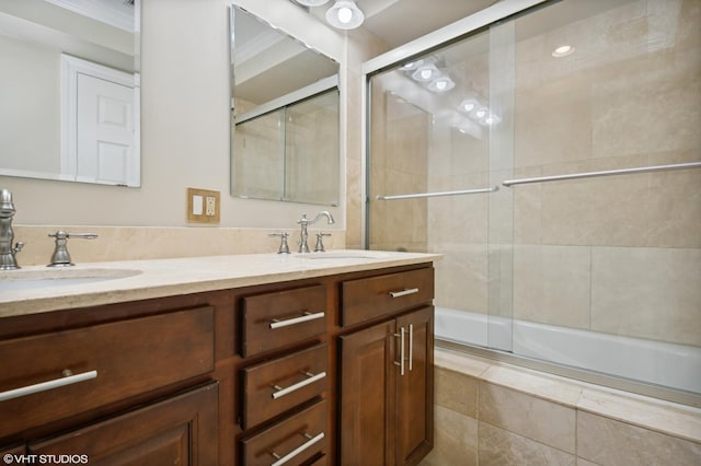 bathroom featuring vanity, enclosed tub / shower combo, and ornamental molding