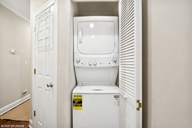 laundry room with hardwood / wood-style flooring, stacked washer / drying machine, and ornamental molding