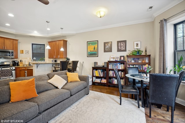 living room featuring crown molding and light hardwood / wood-style floors