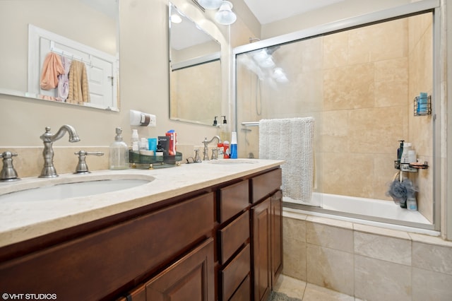 bathroom featuring tile patterned flooring, vanity, and tiled shower / bath combo