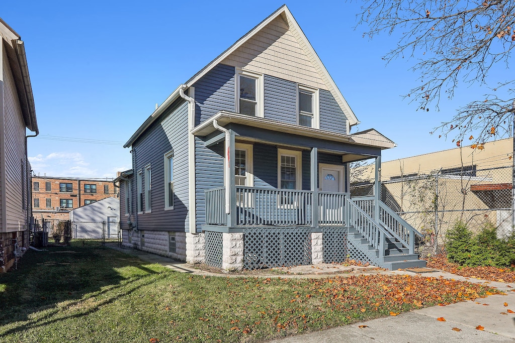 view of front of home featuring covered porch and a front yard