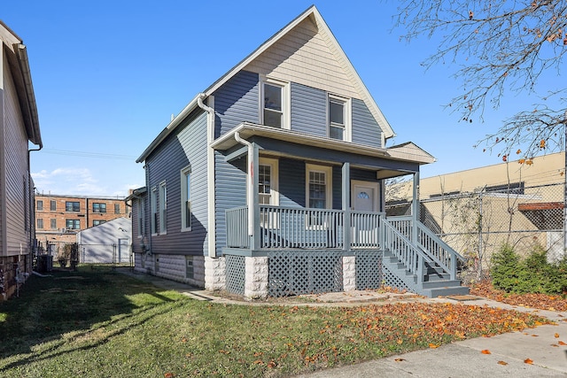 view of front of home featuring covered porch and a front yard