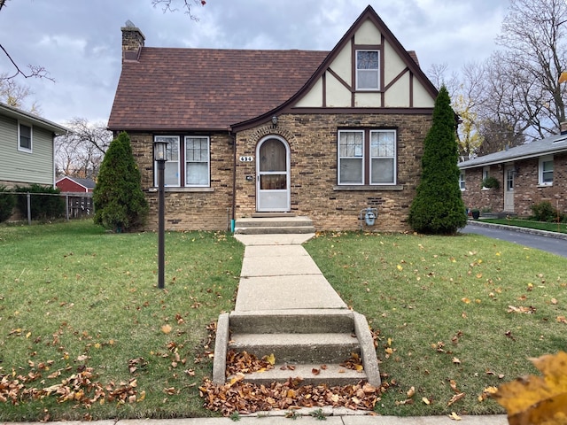 tudor-style house with a front yard