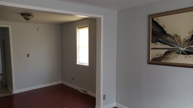 empty room featuring dark hardwood / wood-style flooring