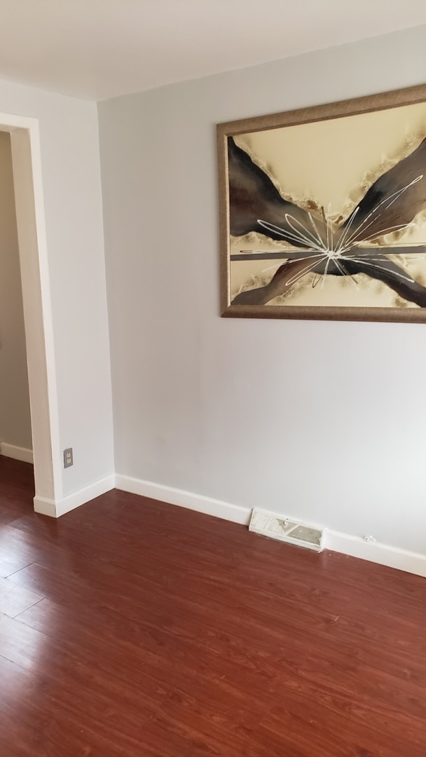 empty room featuring dark wood-type flooring