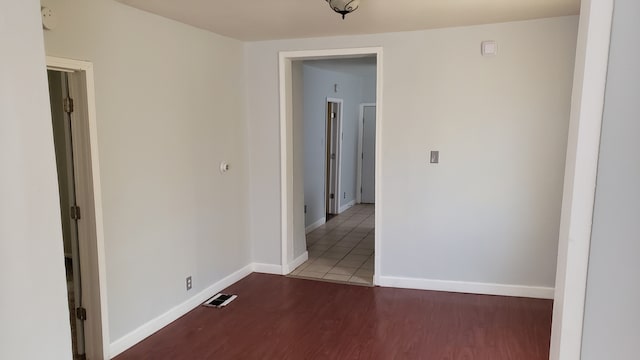 unfurnished room with dark hardwood / wood-style floors