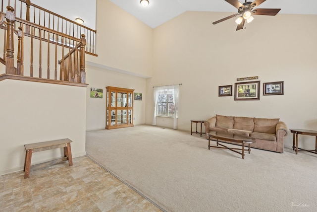 living room with ceiling fan, high vaulted ceiling, and light carpet