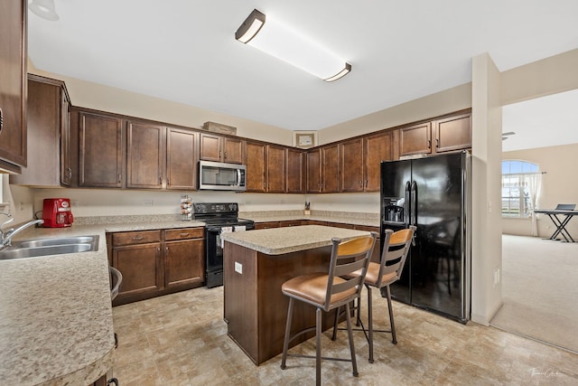 kitchen with a center island, sink, a kitchen bar, light carpet, and black appliances