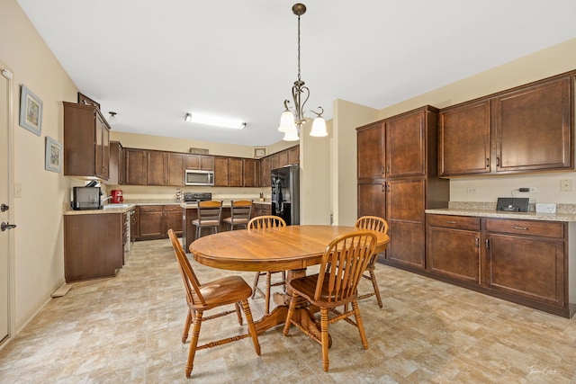 dining room with sink and a chandelier