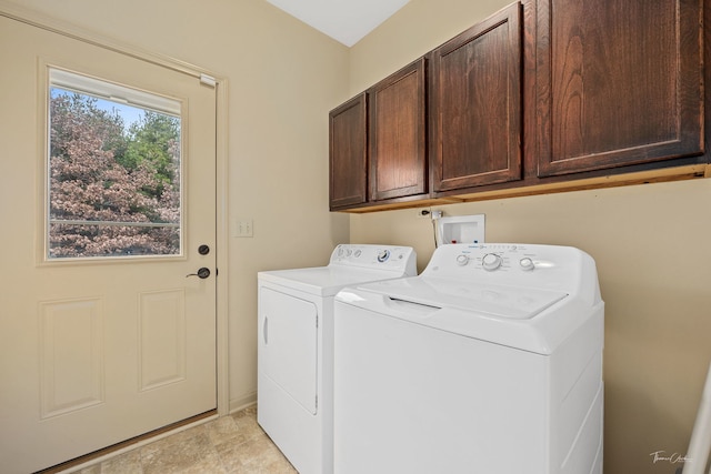 clothes washing area with cabinets and washer and dryer