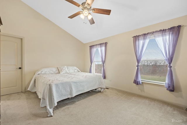 carpeted bedroom with vaulted ceiling, multiple windows, and ceiling fan