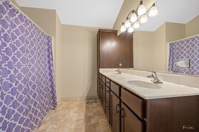 bathroom featuring vanity and lofted ceiling