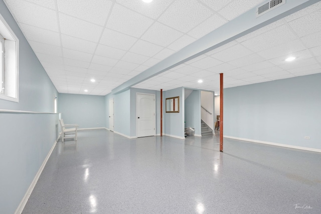 basement featuring a paneled ceiling