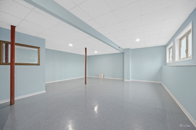 basement with a paneled ceiling