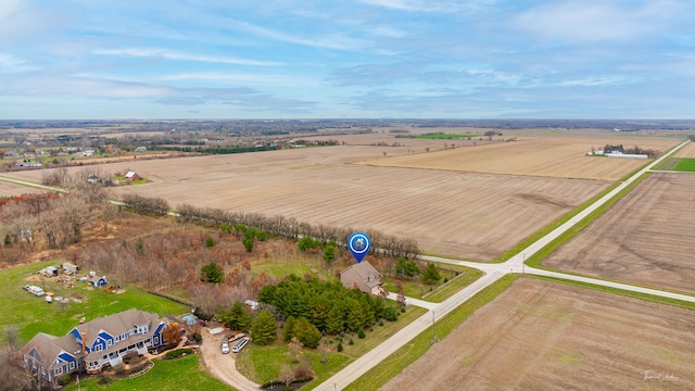 birds eye view of property with a rural view