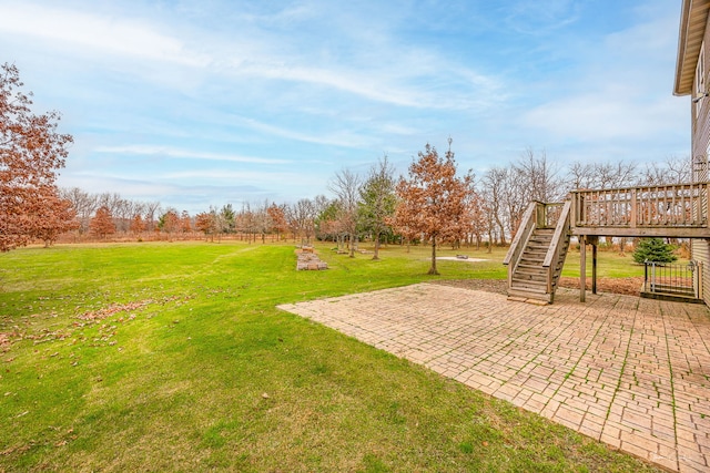 view of yard with a patio area and a wooden deck