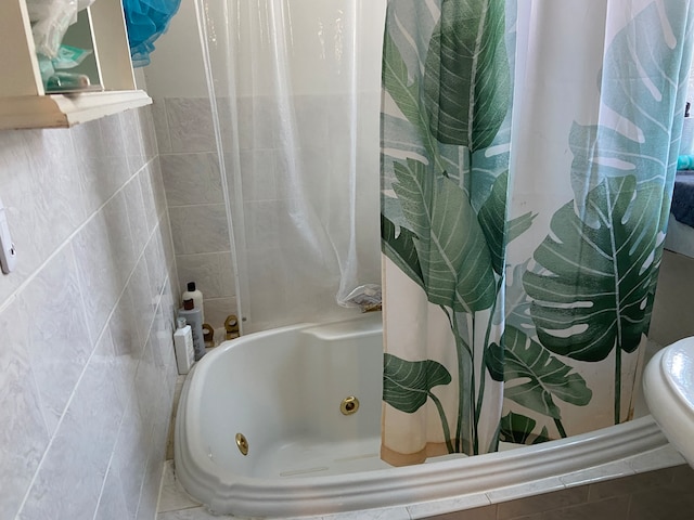 bathroom with shower / bath combo with shower curtain