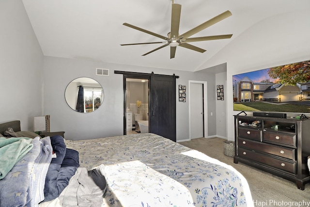 bedroom featuring lofted ceiling, ensuite bath, ceiling fan, a barn door, and light colored carpet