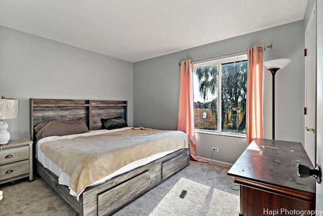 bedroom featuring light carpet