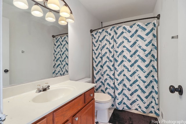 bathroom with tile patterned floors, a shower with curtain, vanity, and toilet