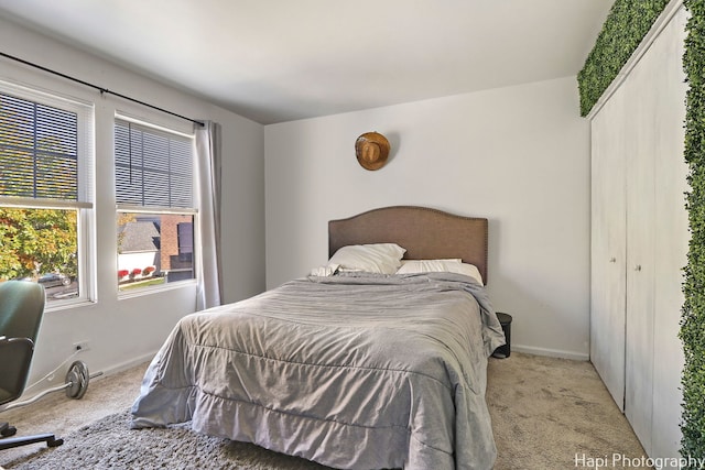 bedroom featuring a closet and light colored carpet