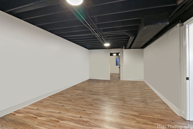 basement with hardwood / wood-style flooring