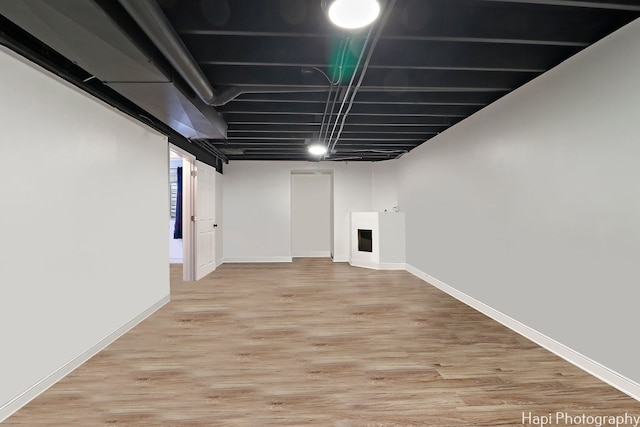 basement with hardwood / wood-style floors