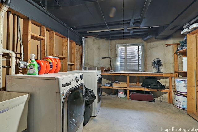 basement with washing machine and dryer and sink