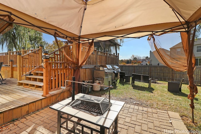 view of patio / terrace featuring a fire pit, a gazebo, and a deck