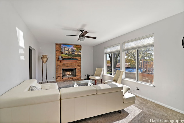 carpeted living room featuring ceiling fan and a brick fireplace