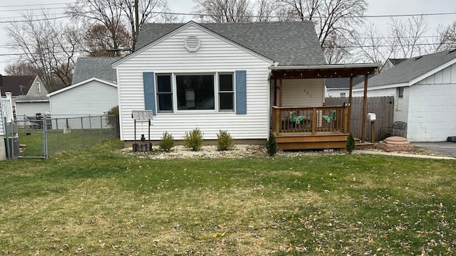 rear view of property with a yard