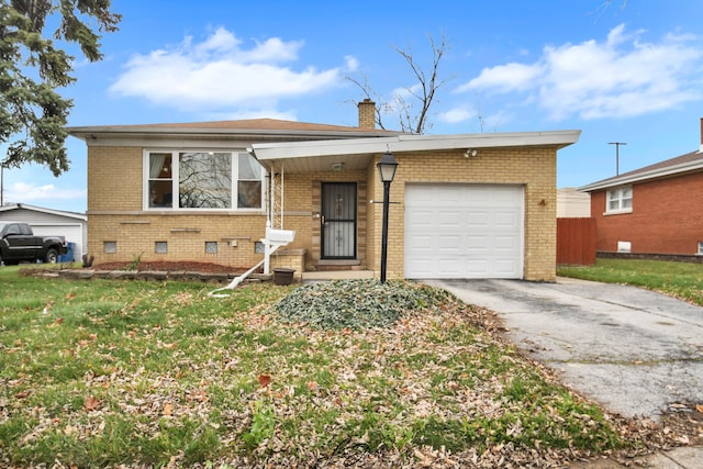 single story home featuring a garage and a front lawn