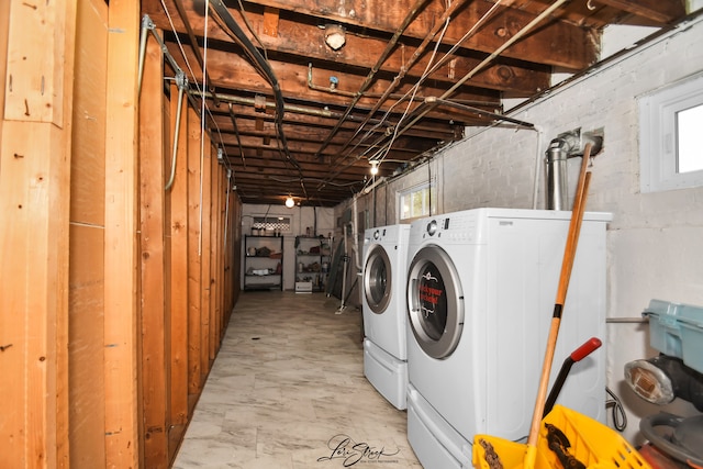 washroom featuring plenty of natural light and washer and dryer