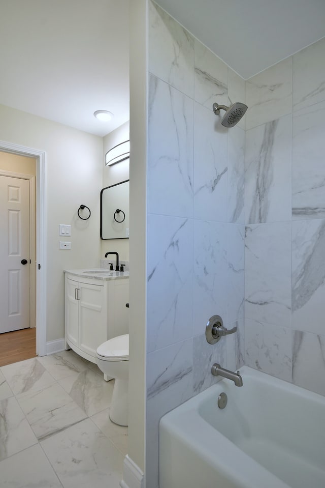 full bathroom featuring toilet, vanity, and tiled shower / bath