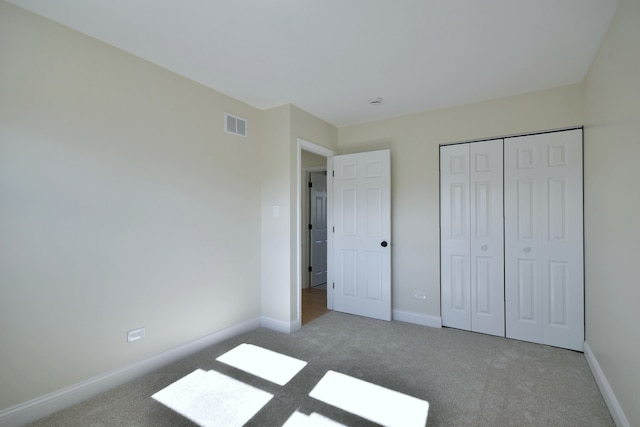 unfurnished bedroom with carpet and a closet