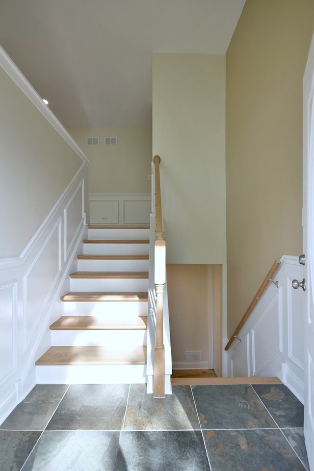 staircase featuring ornamental molding