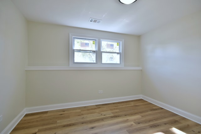 spare room with light hardwood / wood-style flooring