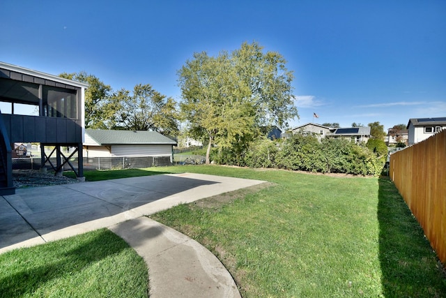 view of yard featuring a sunroom and a patio