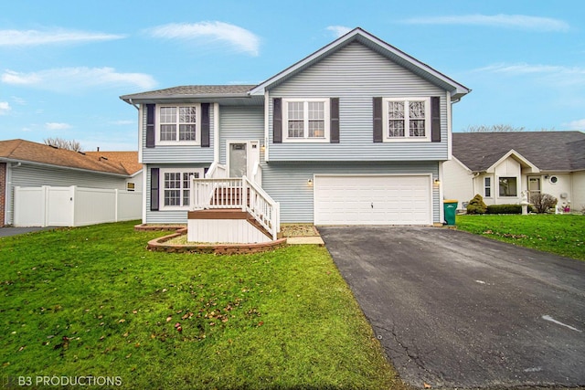 split foyer home featuring a garage and a front lawn