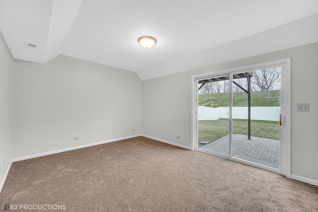 carpeted spare room with lofted ceiling