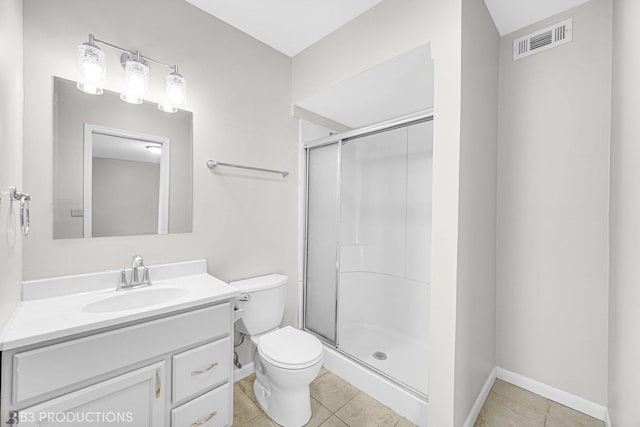 bathroom featuring tile patterned flooring, vanity, toilet, and a shower with shower door