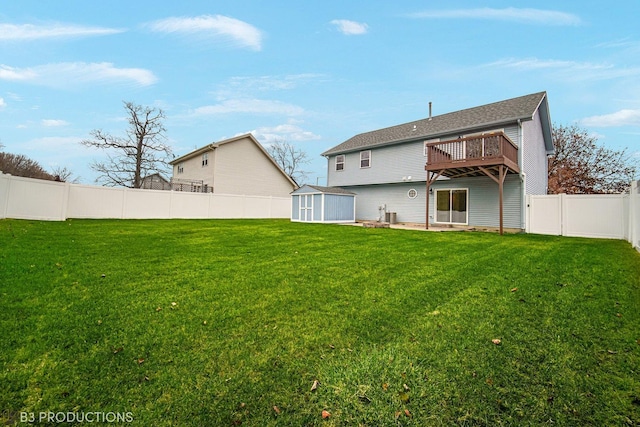 rear view of property with a patio, a deck, a storage shed, and a lawn