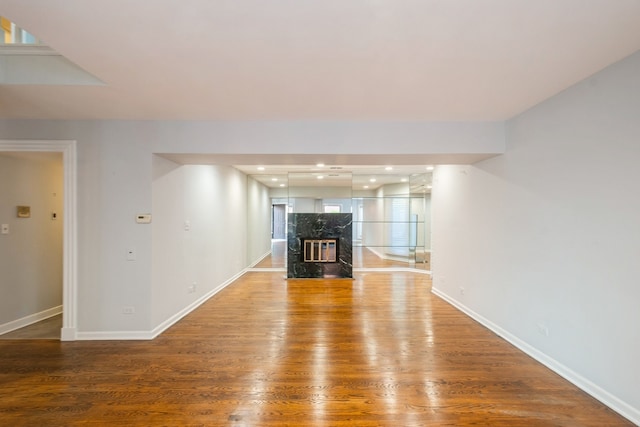 unfurnished living room featuring a fireplace and hardwood / wood-style floors